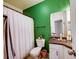 Bathroom featuring a bathtub with a shower, granite countertops, and bright green walls at 4802 51 W St # 1017, Bradenton, FL 34210