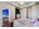 Bright bedroom featuring hardwood floors, a tray ceiling, and an entry into the living room at 4802 51 W St # 1017, Bradenton, FL 34210