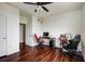 Large bedroom with hardwood floors, featuring two workstations, a ceiling fan, and a closet at 4802 51 W St # 1017, Bradenton, FL 34210