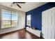 Bright bedroom featuring hardwood floors, a large window, and an accent wall at 4802 51 W St # 1017, Bradenton, FL 34210