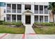 Apartment building featuring screened in patios, manicured landscaping, and common entrance at 4802 51 W St # 1017, Bradenton, FL 34210