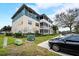 Exterior view of a multi-story apartment building with screened balconies and ample parking at 4802 51 W St # 1017, Bradenton, FL 34210