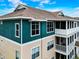 Close aerial of apartment building featuring screened balconies and three-story architecture at 4802 51 W St # 1017, Bradenton, FL 34210