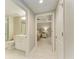 View through doorway into bathroom featuring a shower/tub combo and marble countertop vanity at 501 Haben Blvd # 204, Palmetto, FL 34221