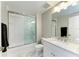 Bathroom with a glass enclosed tub and a marble countertop vanity at 501 Haben Blvd # 204, Palmetto, FL 34221
