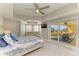 Bedroom with balcony access and ceiling fan for a breezy, relaxing atmosphere at 501 Haben Blvd # 204, Palmetto, FL 34221