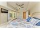 Comfortable bedroom featuring a tray ceiling and access to an outdoor balcony at 501 Haben Blvd # 204, Palmetto, FL 34221