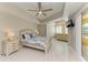 Well-lit bedroom with a king-size bed, ceiling fan, large windows and sliding glass door access to the lanai at 501 Haben Blvd # 204, Palmetto, FL 34221