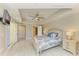Bright bedroom features a ceiling fan, tray ceiling, and sleek marble floors at 501 Haben Blvd # 204, Palmetto, FL 34221