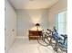Bright bonus room with bikes, a cabinet, and a door at 501 Haben Blvd # 204, Palmetto, FL 34221