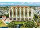 Upscale condo building exterior showcases multiple balconies, a pool, a water fountain, and manicured greenery at 501 Haben Blvd # 204, Palmetto, FL 34221