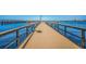Scenic view of a wooden fishing pier stretching out into clear blue waters, perfect for a relaxing day of fishing at 501 Haben Blvd # 204, Palmetto, FL 34221