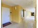 Well-lit hallway with apartment entrance featuring a welcome mat and unit number, inviting ambiance at 501 Haben Blvd # 204, Palmetto, FL 34221