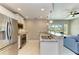 Well-appointed kitchen with stainless steel appliances, granite countertops, and a breakfast bar overlooking the living area at 501 Haben Blvd # 204, Palmetto, FL 34221