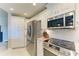 Bright kitchen with white cabinets, stainless steel appliances, and modern fixtures for a sleek cooking space at 501 Haben Blvd # 204, Palmetto, FL 34221