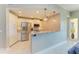 Stylish kitchen featuring white cabinetry, granite countertops, stainless steel appliances, and pendant lighting at 501 Haben Blvd # 204, Palmetto, FL 34221