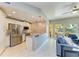 Modern kitchen boasts white cabinets, granite countertops, and stainless steel appliances, open to the living area at 501 Haben Blvd # 204, Palmetto, FL 34221