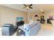 Spacious living room featuring modern decor, ceiling fans, and seamless flow to the dining area at 501 Haben Blvd # 204, Palmetto, FL 34221