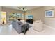 Bright living room with tile floors, contemporary furnishings, and a sliding glass door to the outdoor patio at 501 Haben Blvd # 204, Palmetto, FL 34221