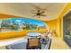 Sunny, yellow patio with a round table and chairs, perfect for outdoor dining and relaxation with beautiful outdoor views at 501 Haben Blvd # 204, Palmetto, FL 34221