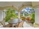 Covered patio with lush landscaping and views of the pond and fountain at 501 Haben Blvd # 204, Palmetto, FL 34221