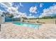 Relaxing pool with lounge chairs, waterfall feature, and clear blue skies above at 501 Haben Blvd # 204, Palmetto, FL 34221