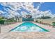 Community pool featuring lounge chairs, privacy landscaping, and a peaceful water feature at 501 Haben Blvd # 204, Palmetto, FL 34221