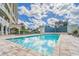 Inviting pool with ample deck space, lounge chairs, and a serene water feature wall at 501 Haben Blvd # 204, Palmetto, FL 34221