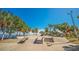 Well-maintained skate park featuring ramps, stairs, and rails, surrounded by lush greenery and palm trees at 501 Haben Blvd # 204, Palmetto, FL 34221