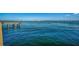 Expansive view of tranquil blue waters, framed by a pier on the left and distant city skyline at 501 Haben Blvd # 204, Palmetto, FL 34221