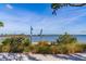 Scenic waterfront view featuring native plants, with a bridge in the distance, offering a tranquil escape at 501 Haben Blvd # 204, Palmetto, FL 34221