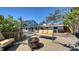 Spacious backyard featuring a screened-in pool area, a wooden deck with cozy seating, and a fire pit at 514 Ralph St, Sarasota, FL 34242
