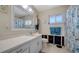 Bathroom featuring a vanity, mirror, toilet, and a shower with decorative blue seashell curtain at 514 Ralph St, Sarasota, FL 34242