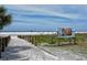 Picturesque Siesta Beach scene with pristine white sands meeting the blue ocean under a clear sky, inviting relaxation and fun at 514 Ralph St, Sarasota, FL 34242