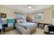 Cozy bedroom featuring a comfortable bed, ceiling fan, and natural light from the window at 514 Ralph St, Sarasota, FL 34242