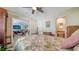 Well-lit bedroom featuring a ceiling fan, neutral walls, and easy access to the living room and bathroom at 514 Ralph St, Sarasota, FL 34242