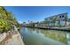 Scenic canal view showcasing a waterfront property with a private dock and lush landscaping at 514 Ralph St, Sarasota, FL 34242