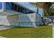 Architectural design of Siesta Beach facility featuring a modern structure with an artistic wall and lush green lawn at 514 Ralph St, Sarasota, FL 34242