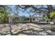 Desirable single-story home with a covered carport, complemented by mature landscaping and a pop of color on the front door at 514 Ralph St, Sarasota, FL 34242