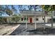 Attractive single-story home featuring a convenient covered carport, inviting curb appeal, and a welcoming red front door at 514 Ralph St, Sarasota, FL 34242