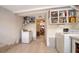 Laundry room featuring a washer, dryer, storage cabinets and tile floors at 514 Ralph St, Sarasota, FL 34242