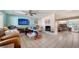 Open-concept living room with a painted brick fireplace, tile floors, and sliders offering great natural light at 514 Ralph St, Sarasota, FL 34242