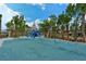 Community playground offers swing sets and a tower with slides surrounded by trees at 514 Ralph St, Sarasota, FL 34242