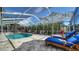 Screened in Pool area featuring a swimming pool, outdoor seating, and an umbrella at 514 Ralph St, Sarasota, FL 34242