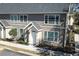 Charming two-story townhome featuring a well-maintained lawn and freshly painted white trim at 5631 Rosehill Rd. Rd # 203, Sarasota, FL 34233