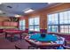 Community game room featuring a pool table, card table, and ample natural light at 5631 Rosehill Rd. Rd # 203, Sarasota, FL 34233