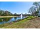 Community pond with fountain surrounded by lush greenery and residential buildings in the background at 5631 Rosehill Rd. Rd # 203, Sarasota, FL 34233