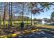 Park area featuring a pond with a fountain and a nearby parking area at 5631 Rosehill Rd. Rd # 203, Sarasota, FL 34233