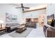 Living room area with neutral decor, ceiling fan, and a partial kitchen view at 5688 Lake Vista Ct # 31, Sarasota, FL 34233