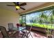 Relaxing screened patio with an outdoor dining set and views of the lush backyard at 5688 Lake Vista Ct # 31, Sarasota, FL 34233